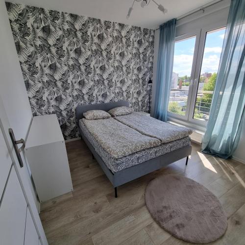 Postel nebo postele na pokoji v ubytování Apartament Skarbowa Sol
