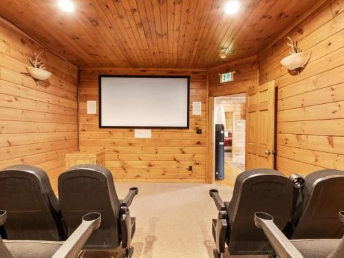 a conference room with a screen in the wall at The Great Escape II, 5 Bedrooms, Sleeps 17, Game Room, Pool Access, Theater in Gatlinburg