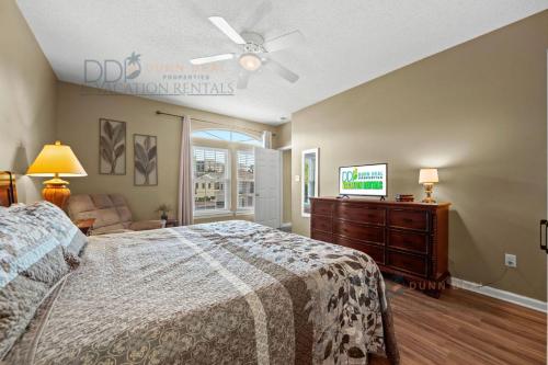 a bedroom with a bed and a flat screen tv at Legacy Villa 704 in Gulfport