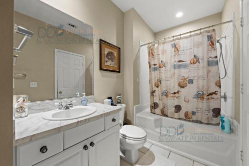 a bathroom with a sink and a shower curtain at Legacy Villa 704 in Gulfport