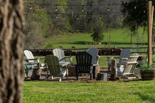 a group of chairs and tables in the grass at Carlton Marion Inn in Yellville