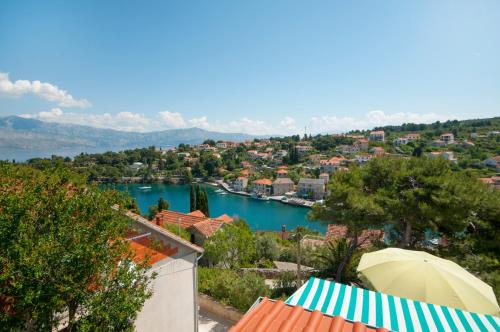 a view of a city and a river with an umbrella at Apartment Agata in Splitska