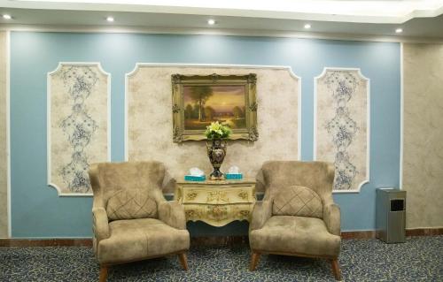 two chairs and a table in a room at Nile Transportation hotel in Cairo