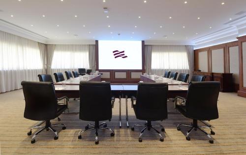 a conference room with a large table and chairs at Crowne Plaza Bahrain by IHG in Manama