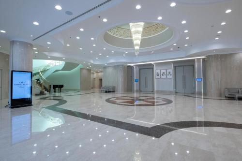 a large room with a lobby with a large ceiling at Crowne Plaza Bahrain by IHG in Manama