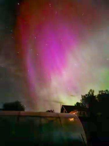 an aurora in the sky over a truck at Naturparadies und Angeloase Borgvik in Borgvik