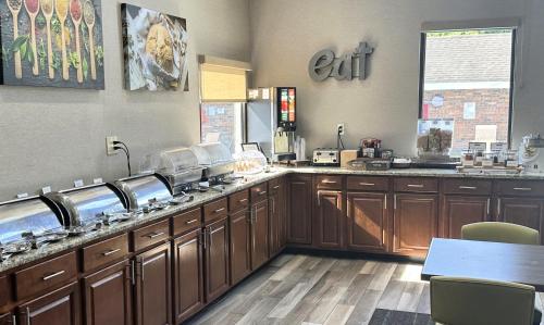 a large kitchen with wooden cabinets and a counter top at Residence Inn Hartford Windsor in Windsor