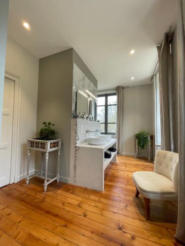 une salle de bain avec un lavabo et un miroir dans l'établissement Chateau aux portes du circuit des 24h, à Yvré-lʼÉvêque