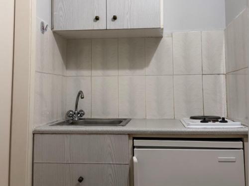 a kitchen with a sink and a counter top at Villa Konstantina in Tolo