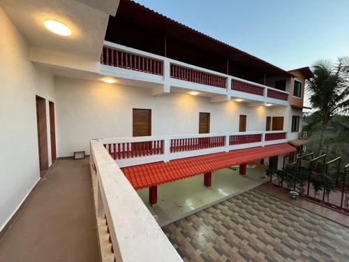 a building with a red bench in front of it at Golden bliss Resort and Pool in Nagaon