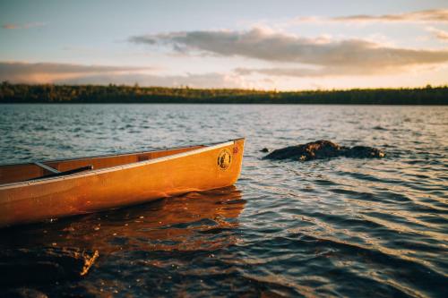 a boat sitting in the water on a lake at Wolf Point Cabin in Boulder Junction WI in Sayner