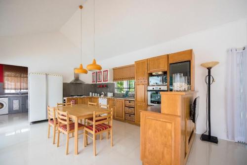 a kitchen with a table and chairs and a refrigerator at Holiday Villa in Balaclava