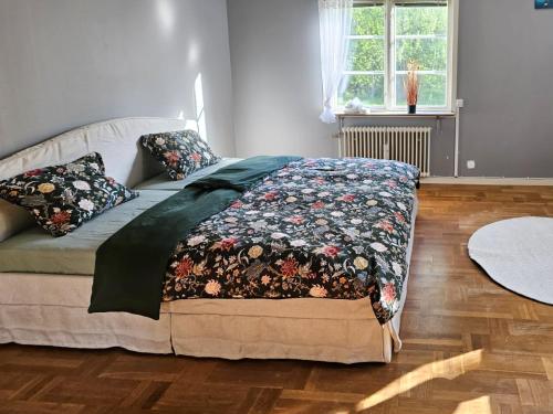 a bed with a blanket on it in a bedroom at Naturparadies und Angeloase Borgvik in Borgvik