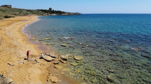 a person standing on a beach near the water at In pieno centro in Crotone