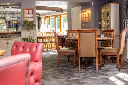 a dining room with a table and chairs at The Black Swan Inn in Norwich