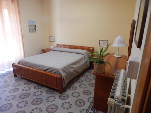 a bedroom with a bed and a plant in it at In pieno centro in Crotone