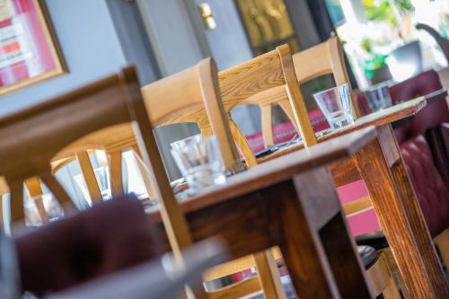 a table with chairs and glasses on top of it at The Black Swan Inn in Norwich