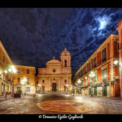 a building with a tower in the middle of a street at In pieno centro in Crotone