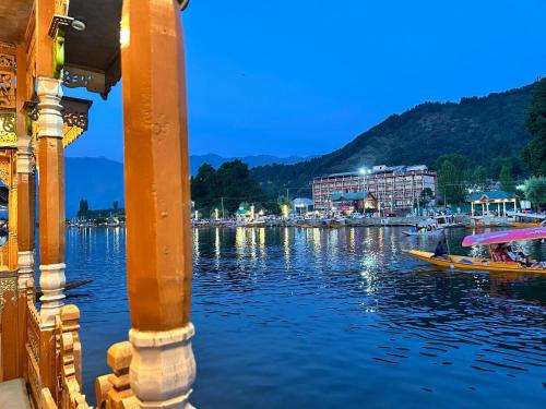 a boat on the water next to a city at Houseboat Trambak in Srinagar