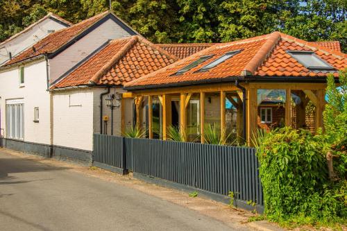 a house with an orange roof on a street at The Black Swan Inn in Norwich
