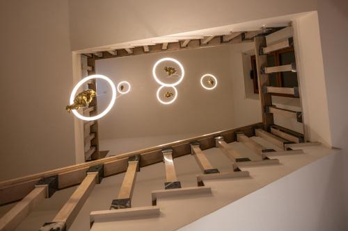a room with stairs and circles on the wall at Hotel Moderno in Assisi
