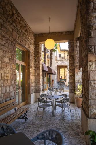 a patio with tables and chairs and a building at Hotel Moderno in Assisi