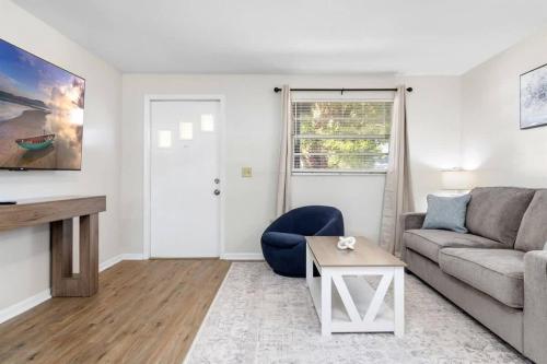 a living room with a couch and a table at Charming Duplex in Zephyrhills! #2 in Zephyrhills