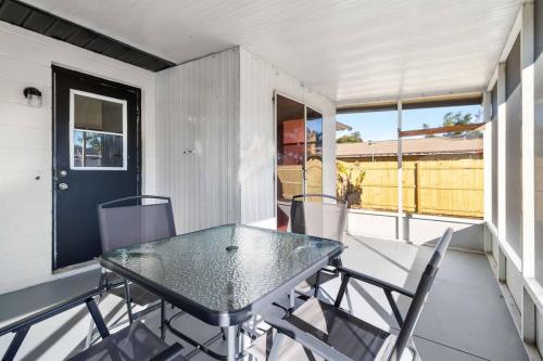 a patio with a table and chairs on a balcony at Charming Duplex in Zephyrhills! #2 in Zephyrhills