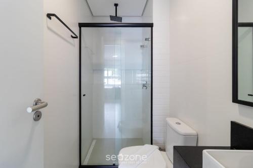a glass shower door in a bathroom with a toilet at SPA - Studios incríveis em Floripa-SC in Florianópolis