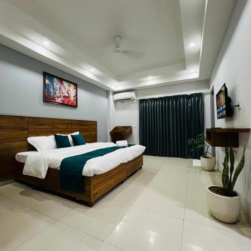 a bedroom with a large bed in a room at JNS Roost in Gurgaon