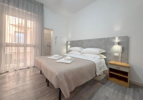 Postel nebo postele na pokoji v ubytování Hotel Ariva