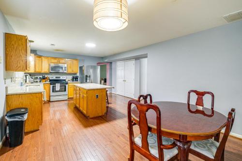 a kitchen with a wooden table and a dining room at Family Retreat with Fenced Yard in Woodbridge! in Woodbridge