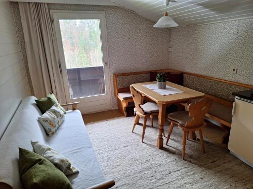 a room with a table and a bed and a table and chairs at Ferienwohnung Rüf in Bizau
