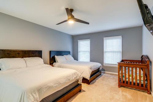 a bedroom with two beds and a ceiling fan at Family Retreat with Fenced Yard in Woodbridge! in Woodbridge