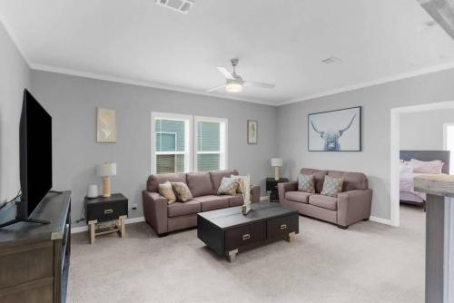 a living room with two couches and a tv at Comfy 2 Bedroom home, Dade City! in Dade City