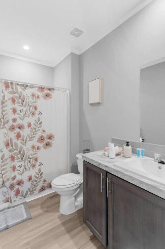 a bathroom with a toilet and a sink at Comfy 2 Bedroom home, Dade City! in Dade City