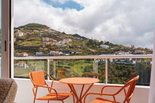a table and chairs in front of a window at GuestReady - Duplex paradise in Caniço in Caniço