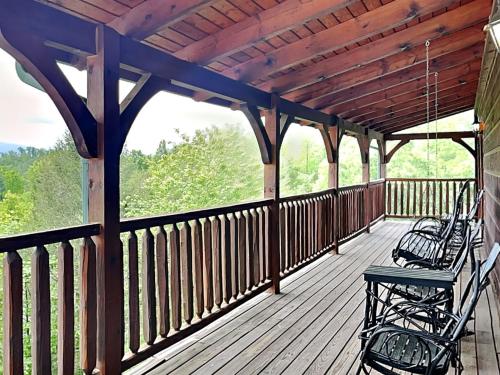 a porch with two benches on a wooden deck at The Great Escape II, 5 Bedrooms, Sleeps 17, Game Room, Pool Access, Theater in Gatlinburg