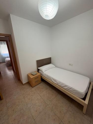 a small bedroom with a bed and a light at Pool Center in Caudete
