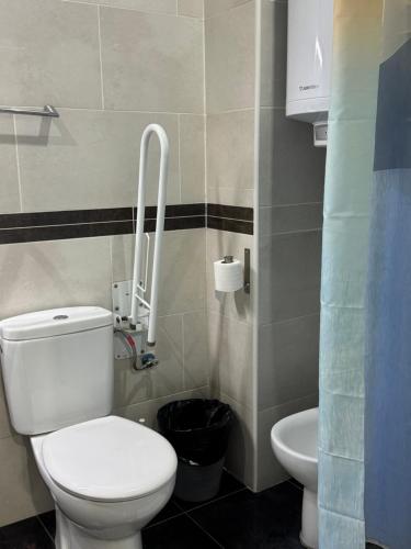 a bathroom with a white toilet and a sink at Hostal Granvia 628 in Barcelona