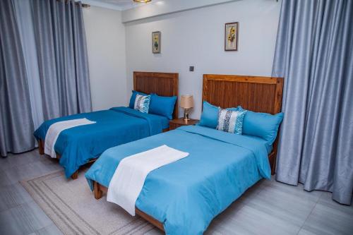 Katil atau katil-katil dalam bilik di Glam Accomodations Bukoto