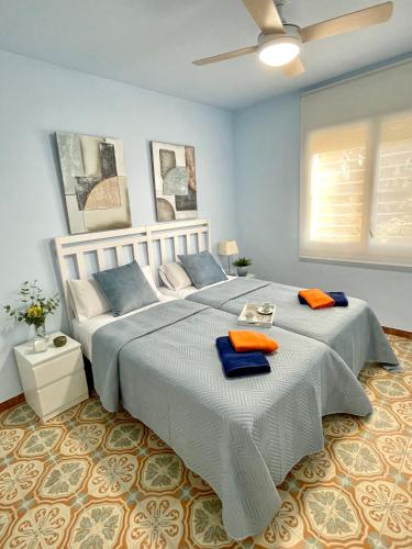 a bedroom with a large bed with two towels on it at MASIA EN COSTA DORADA y CLIMATIZADA in Reus