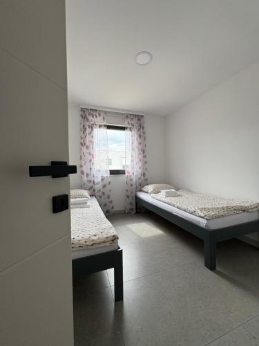 a room with two beds and a window at Apartment Delux in Posušje