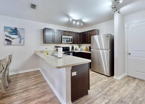a kitchen with a counter and a refrigerator at Brooksville Retreat! 3 Bed, 2 Bath! in Brooksville
