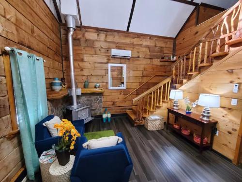 a living room with wood paneling and stairs at The Outdoor Oasis You Get 685 Attraction Tickets per paid day in Kodak