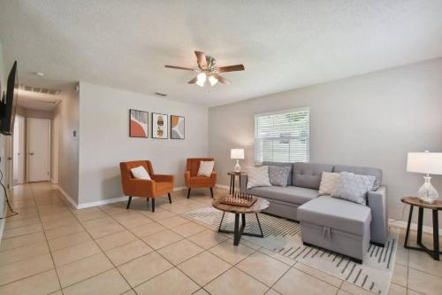 a living room with a couch and a ceiling fan at Comfortable Home in Dade City! in Dade City