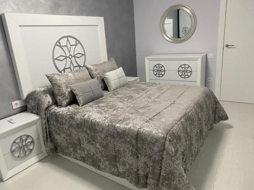 a bedroom with a large bed and a mirror at Casa esperanza in Soria