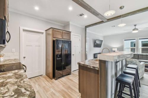 a kitchen with a black refrigerator and a counter at 2 Bed Cozy Home, Dade City, Pickle Ball and Pool in Dade City