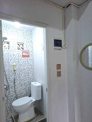 a bathroom with a toilet and a shower at M2 Homestay Berastagi in Berastagi