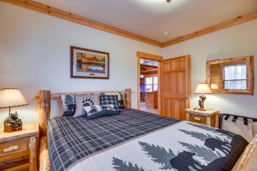 a bedroom with a bed and two night stands and two lamps at Pet-Friendly Garrison Retreat in Garrison